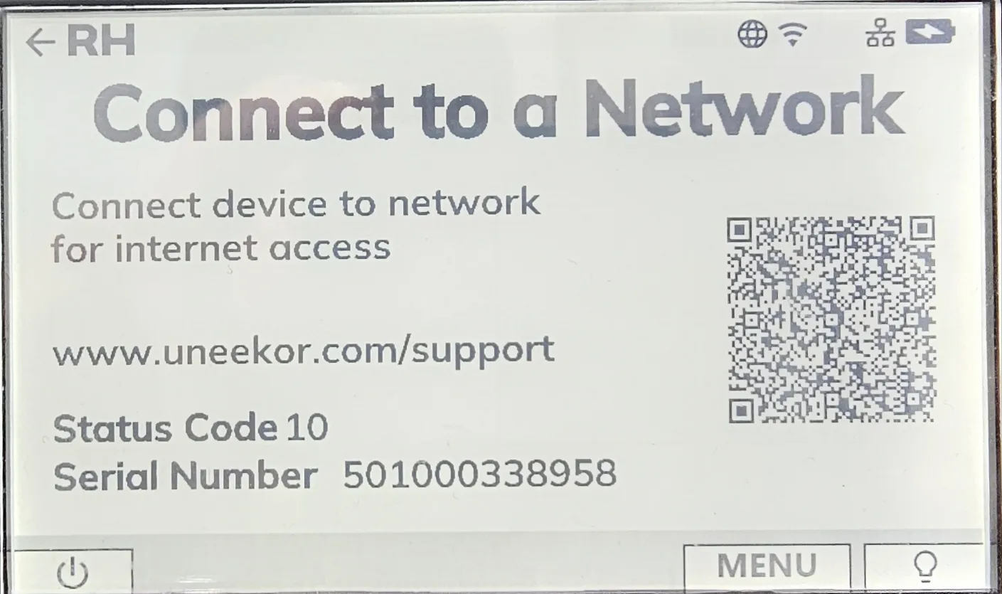 A white screen displaying "Connect to a Network" instructions, a QR code, uneekor.com support URL, Status Code 10, and Serial Number 501000338958.