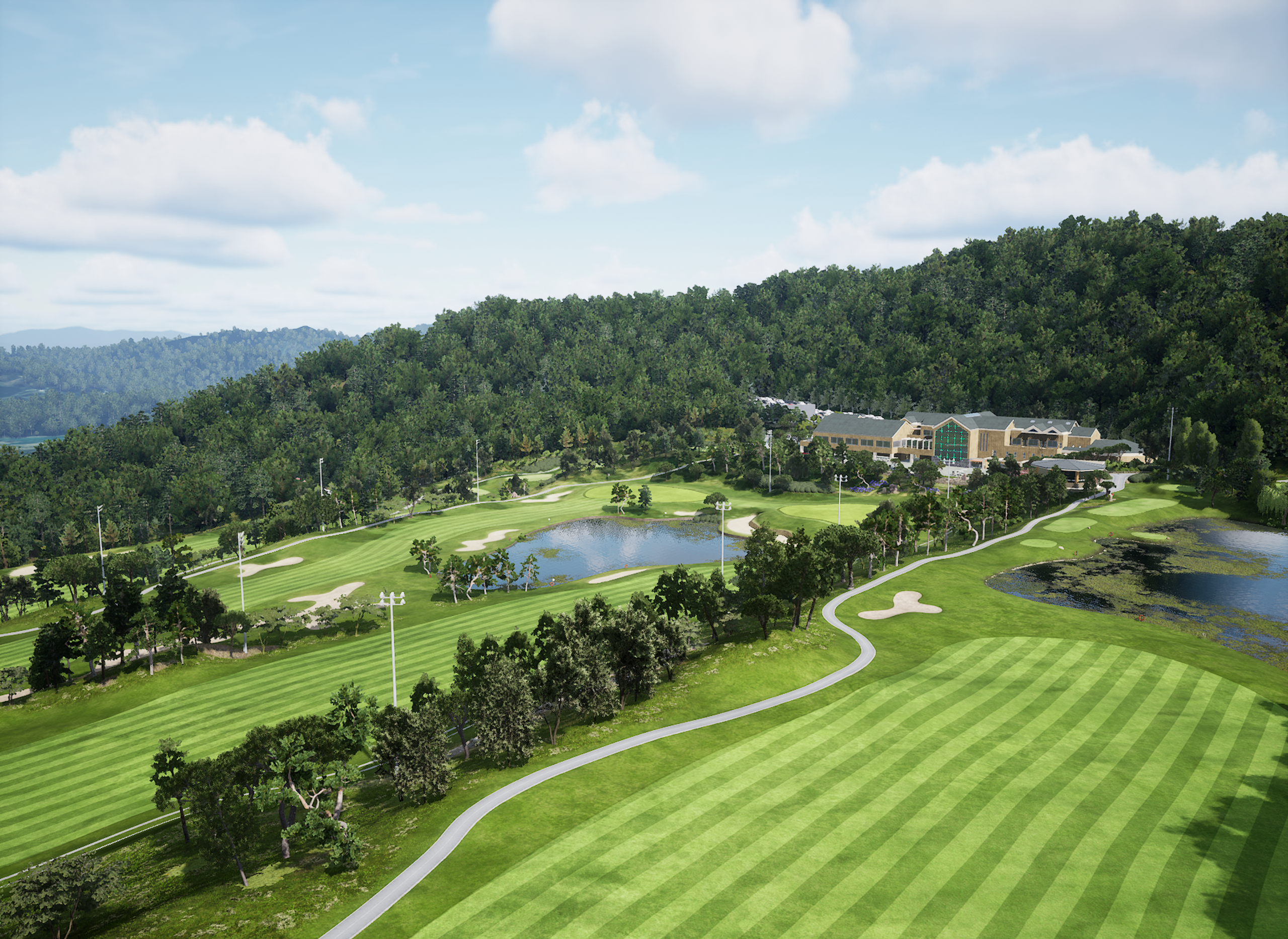 Aerial view of a golf course with green fairways, lakes, a clubhouse, and forested mountains.