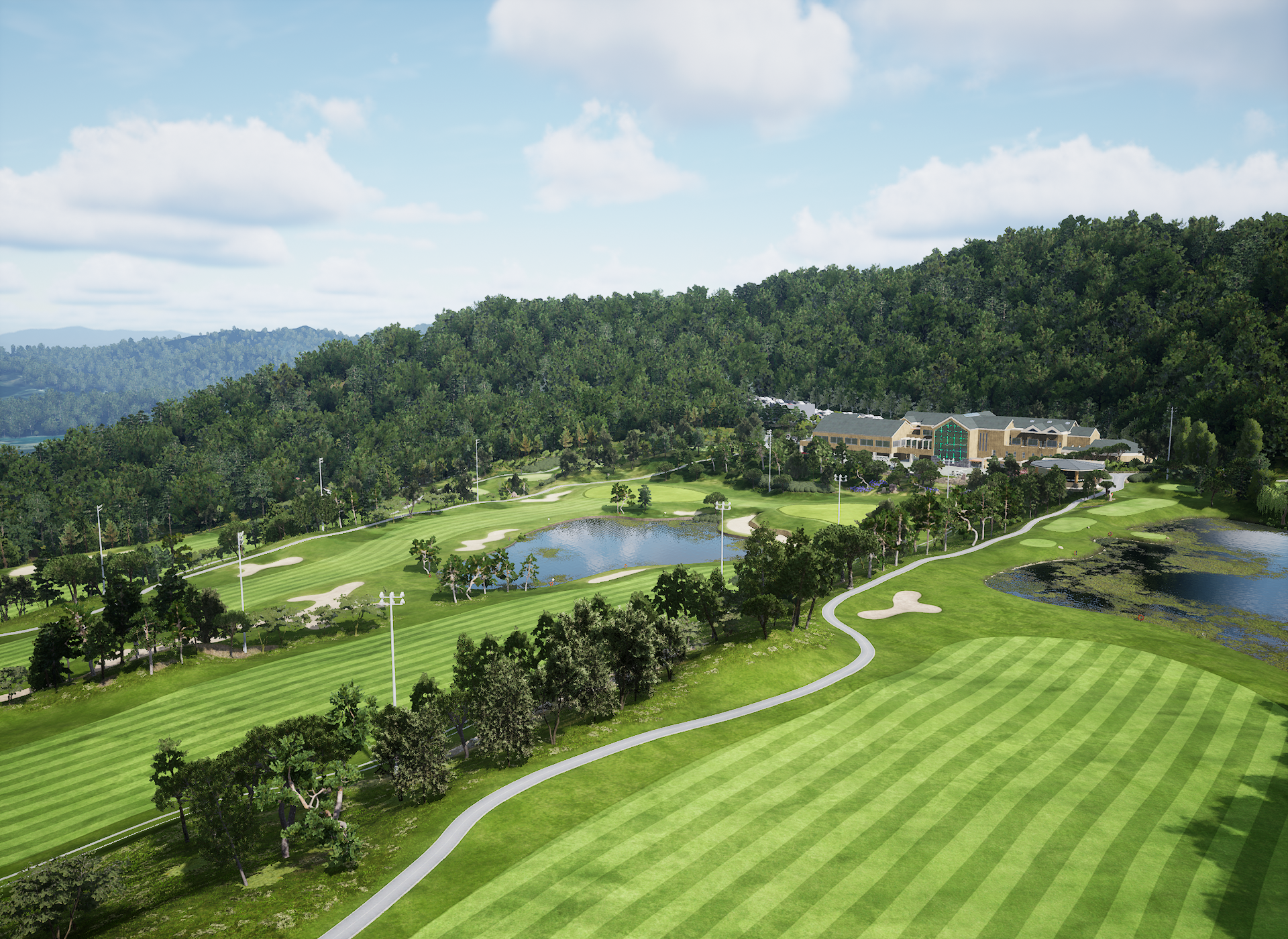 Aerial view of a golf course with green fairways, lakes, a clubhouse, and forested mountains.