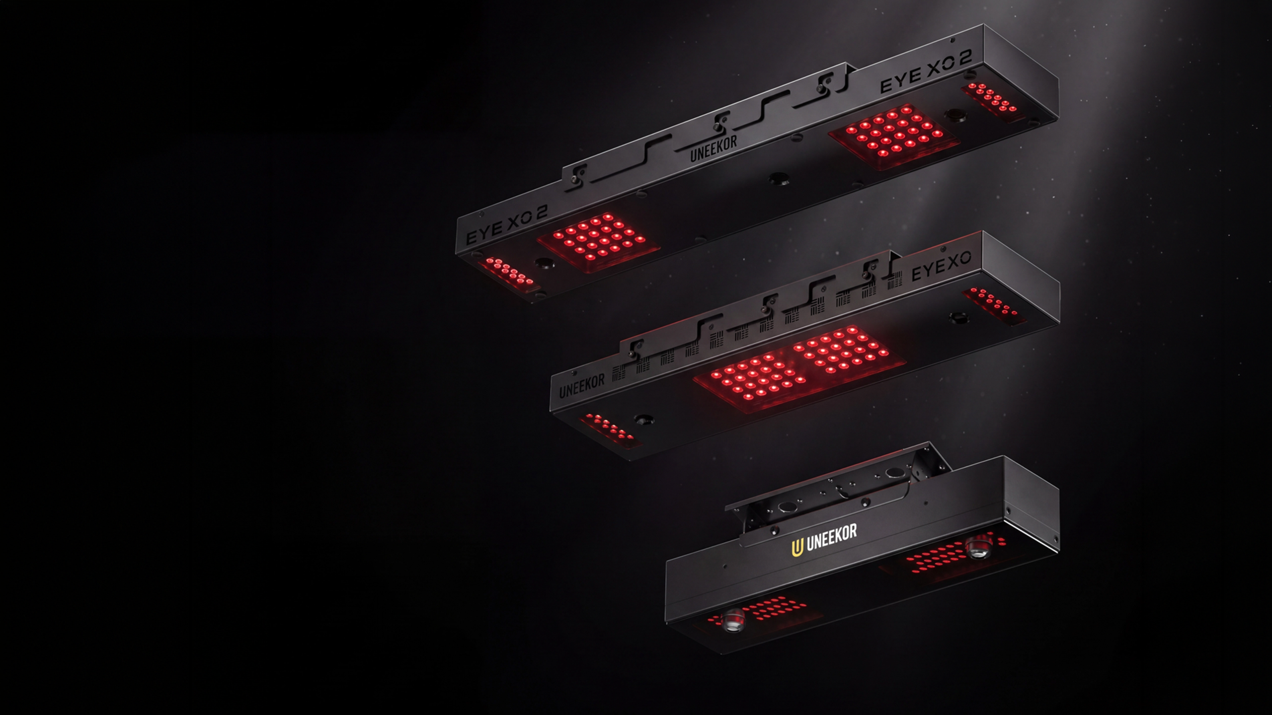 Three black rectangular LED light panels with red lights, labeled 'EYE XO2' and 'UNEEKOR', on a dark background.