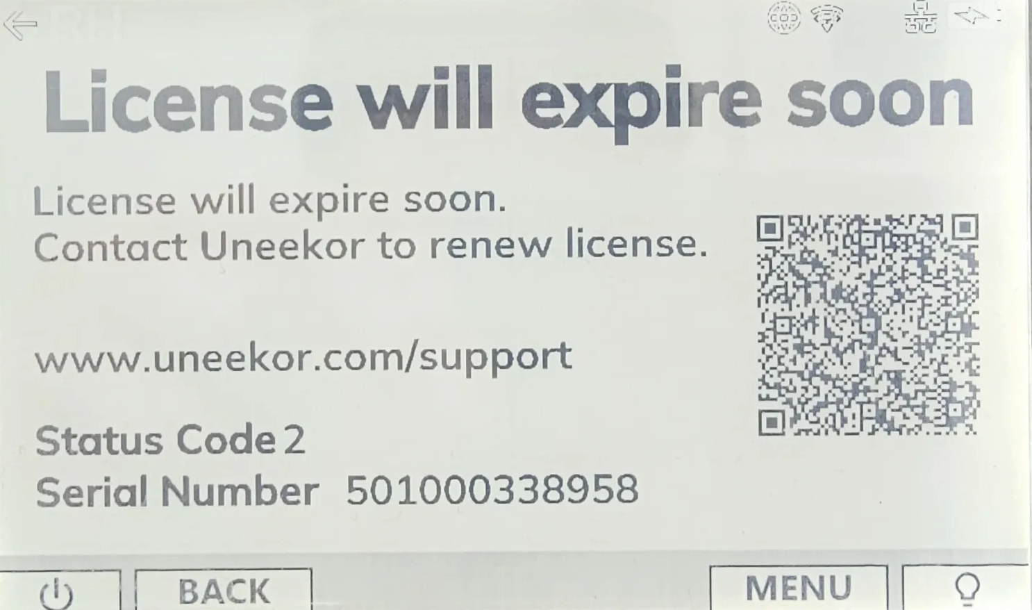 Digital display with a "License will expire soon" message, Uneekor support details, a QR code, and a serial number.