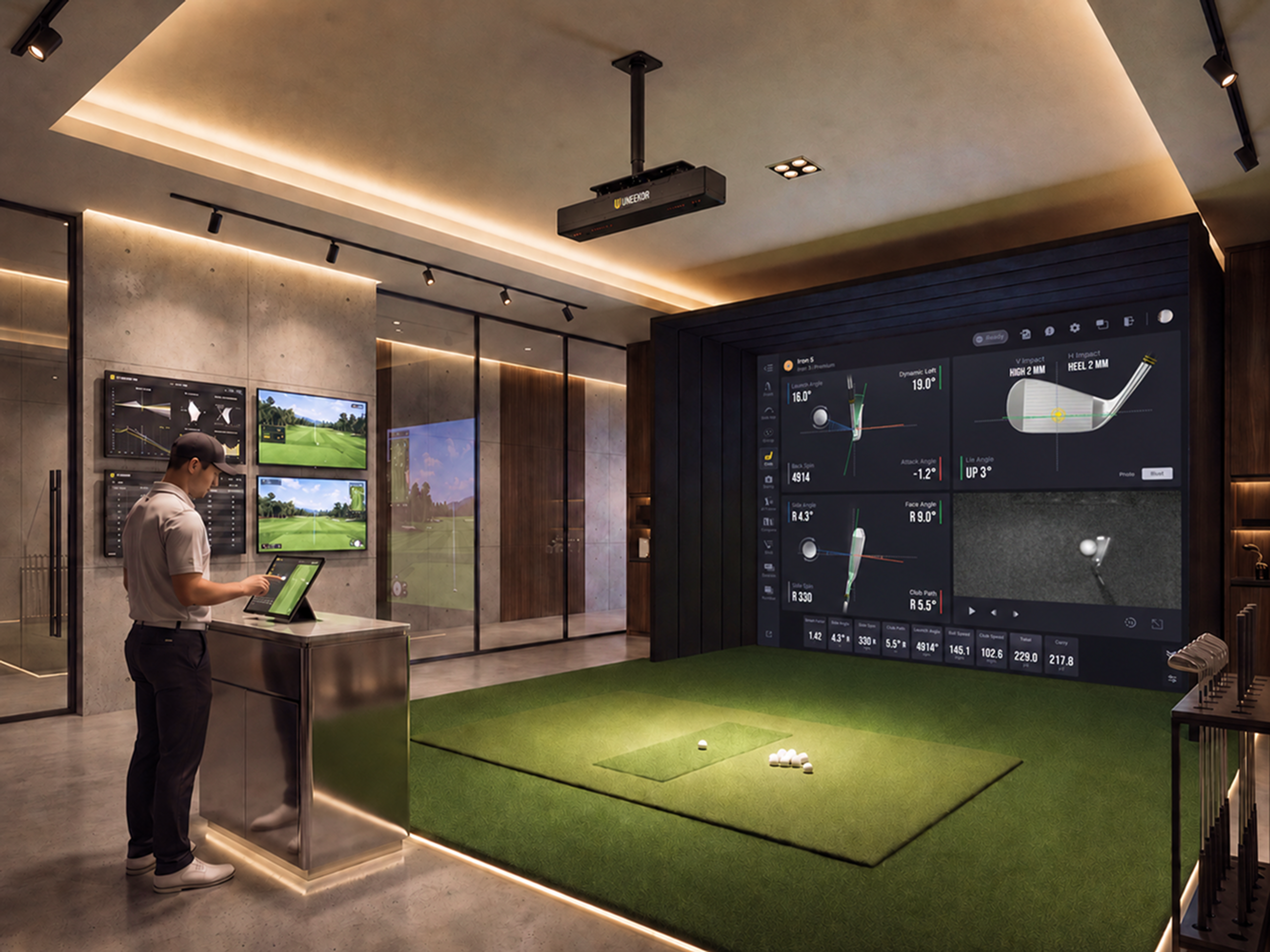 A man operates an indoor golf simulator with a large screen displaying swing data and a virtual golf course, using a tablet at a console.