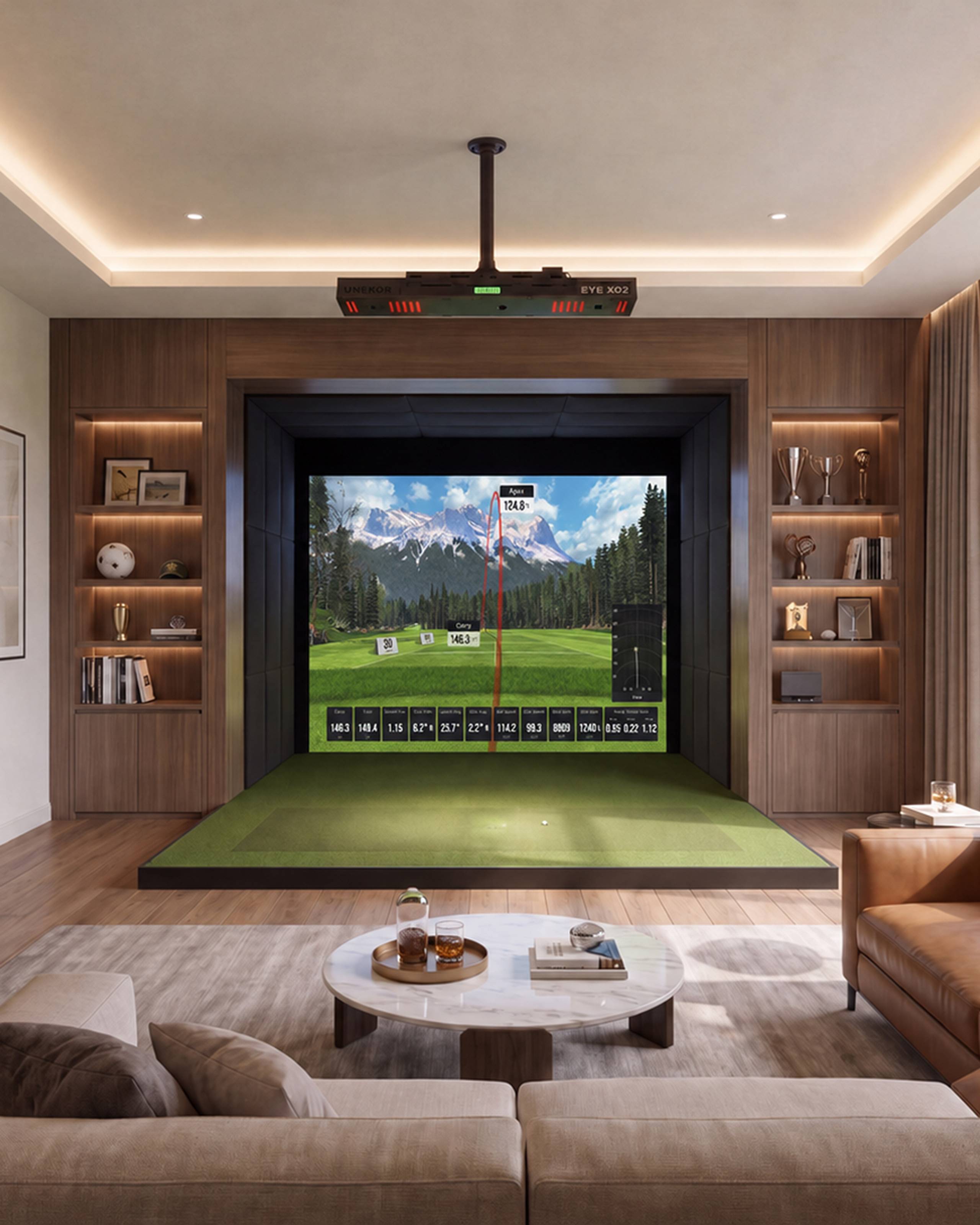 Luxurious home golf simulator room with a mountain course on the screen, a green mat, a ceiling-mounted EYE XO2 launch monitor, and a modern seating area.