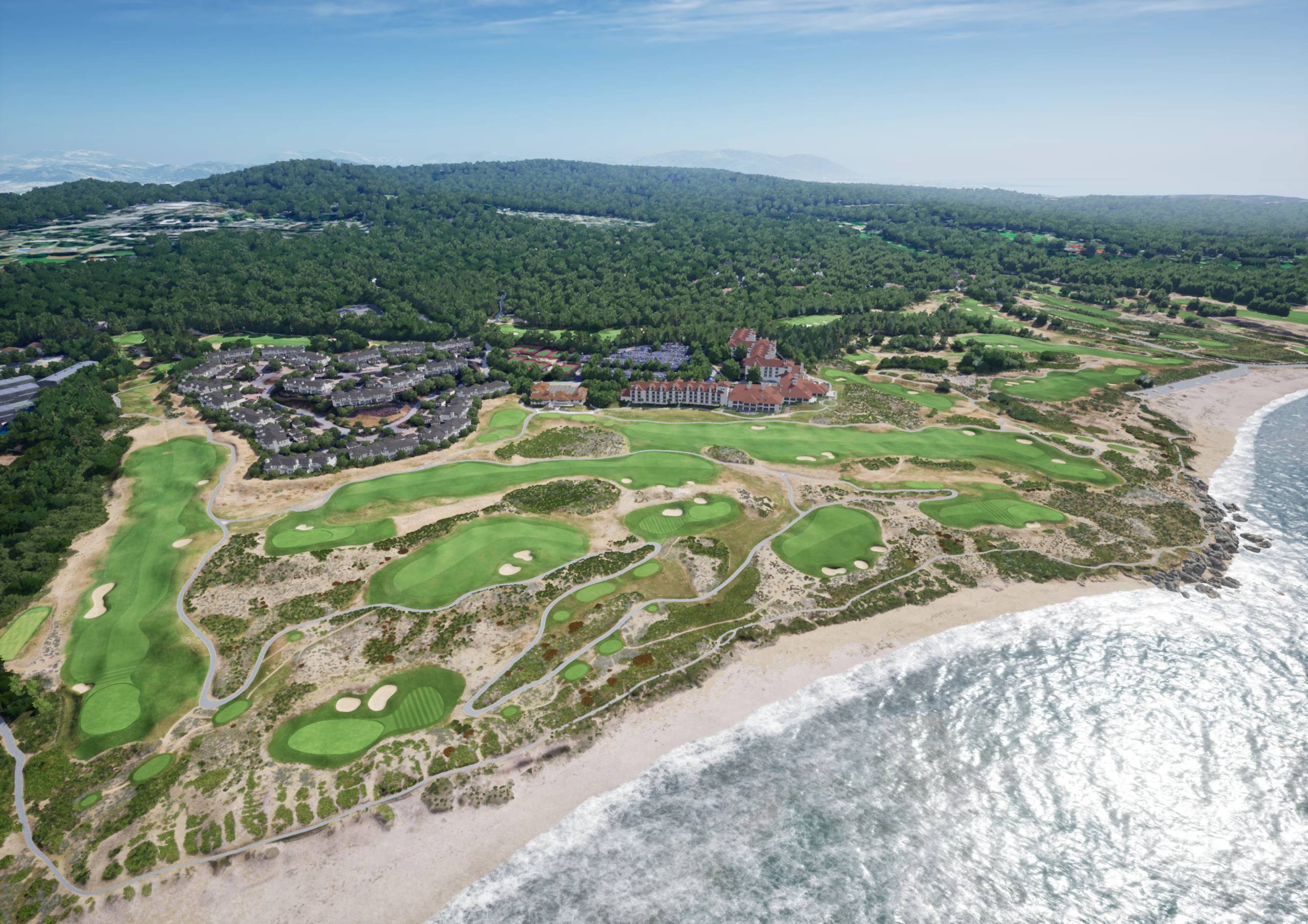 Aerial view of a coastal golf course with a resort, residential area, beach, ocean, and forest.