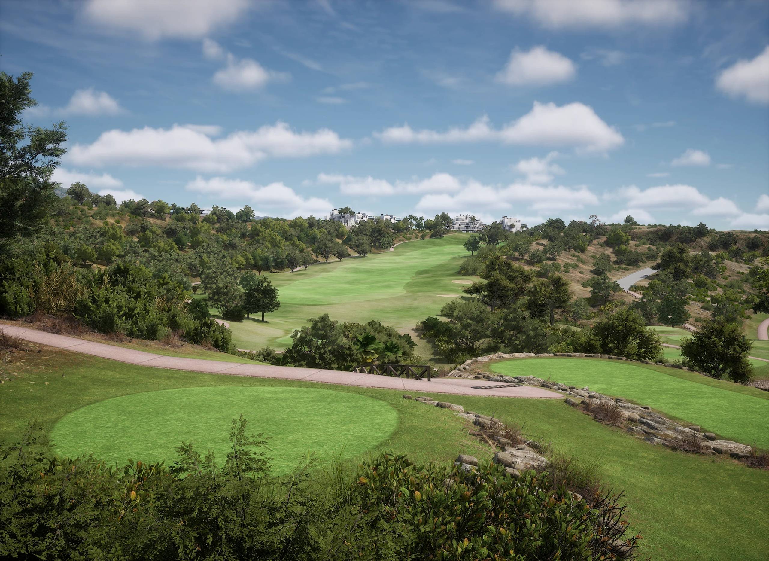A vibrant green golf course winds through a hilly, wooded landscape under a partly cloudy sky.