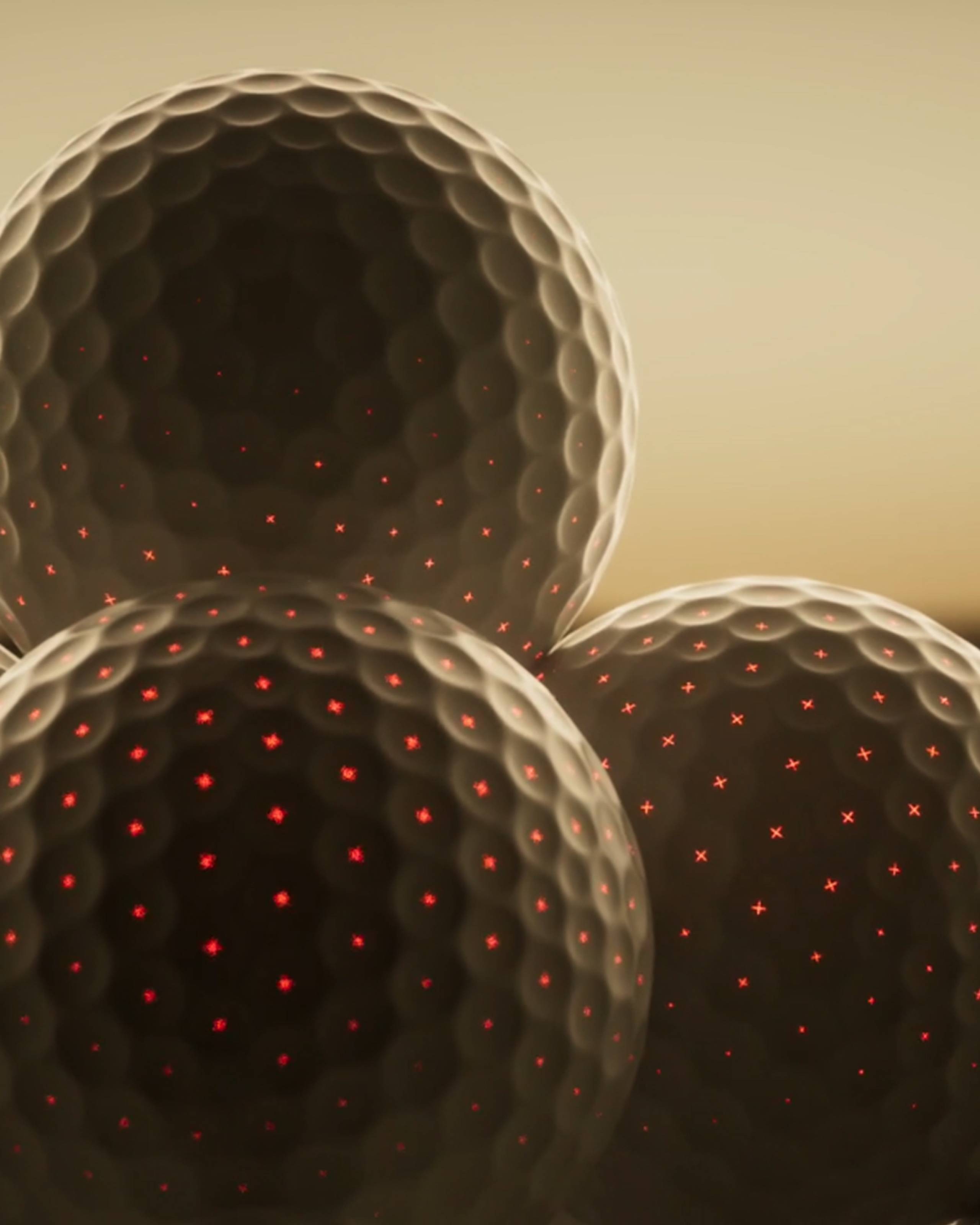 Three dark golf balls with red glowing crosses in their dimples.