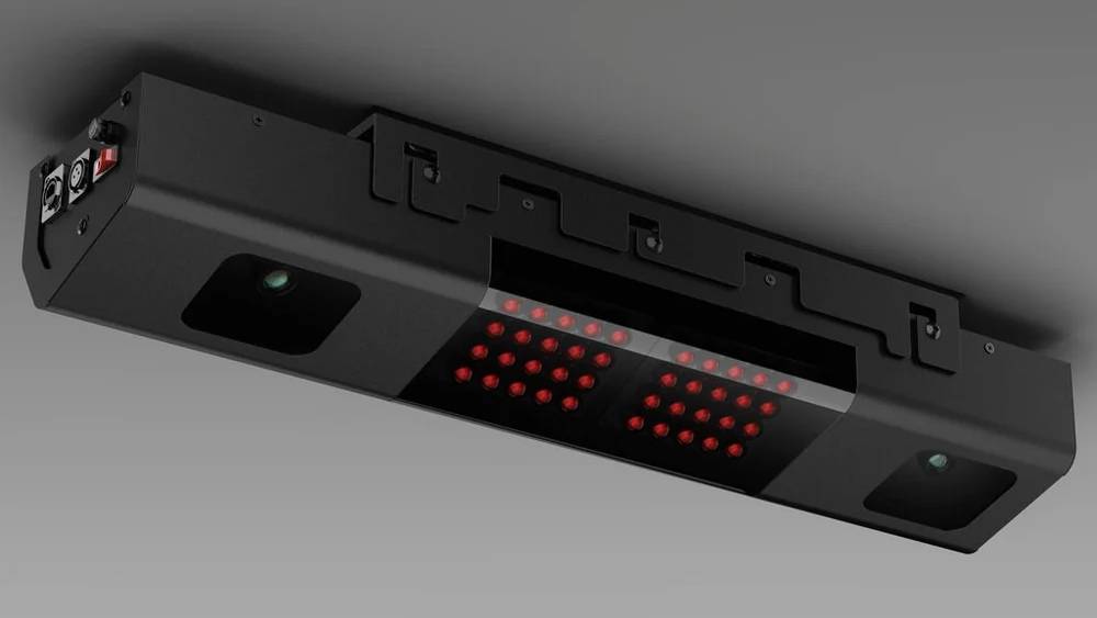 A black ceiling-mounted sensor bar with two rows of red lights and two camera lenses.
