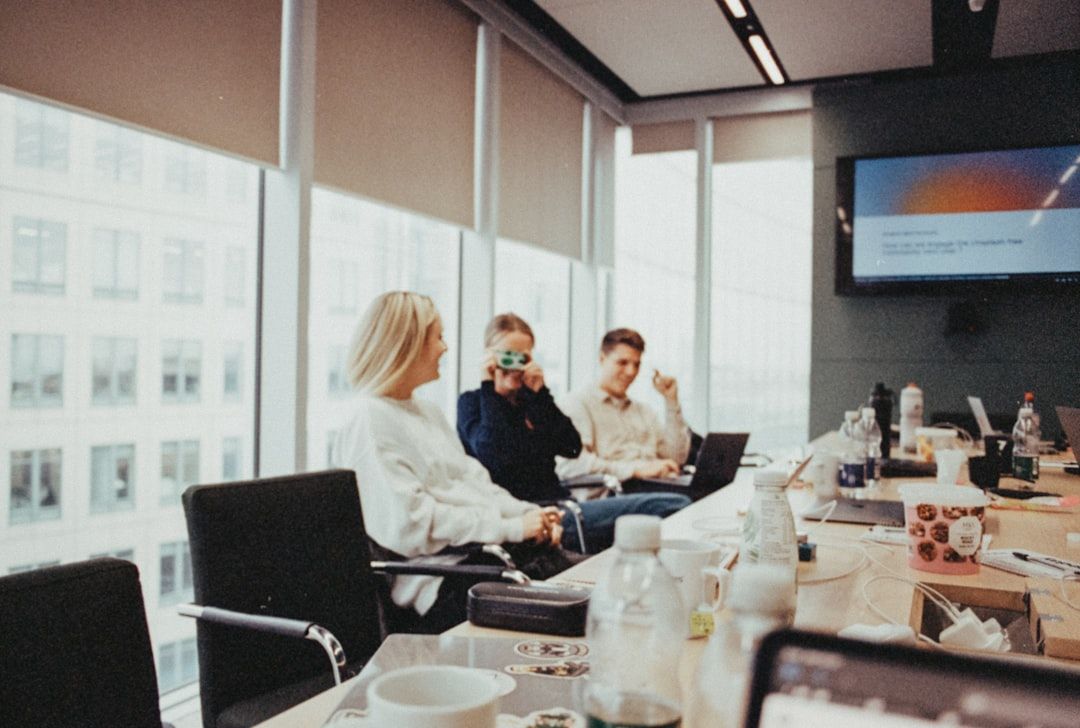 a group of people sitting around a conference room table