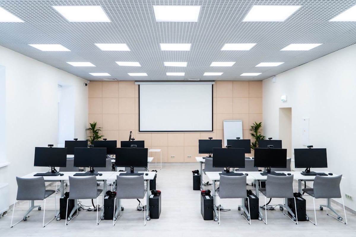 a room filled with lots of desks and computers
