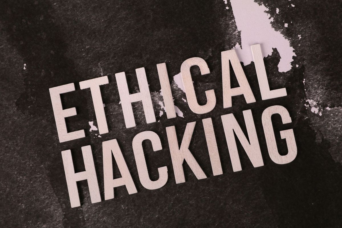 Creative depiction of the term 'Ethical Hacking' on a dark artistic background.