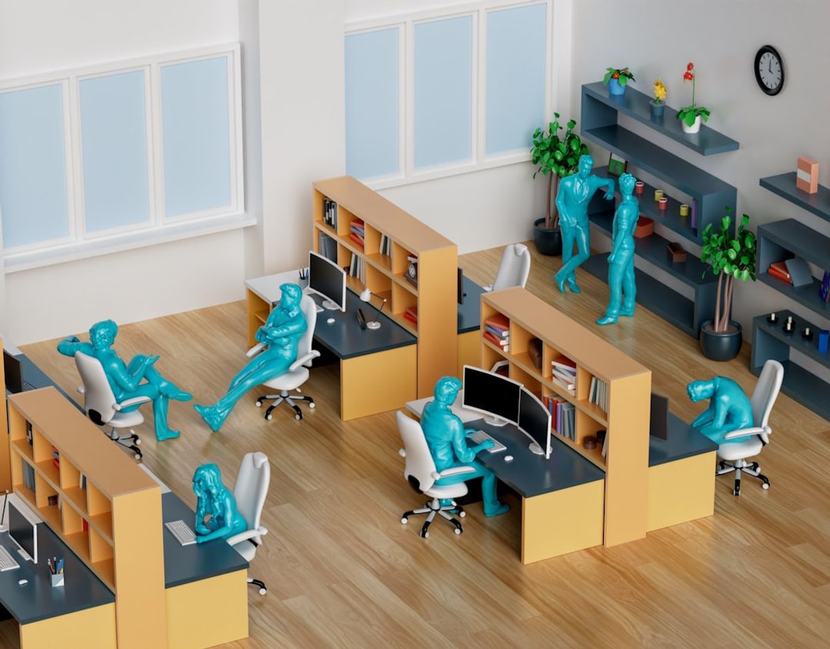 a group of desks with blue figures on them