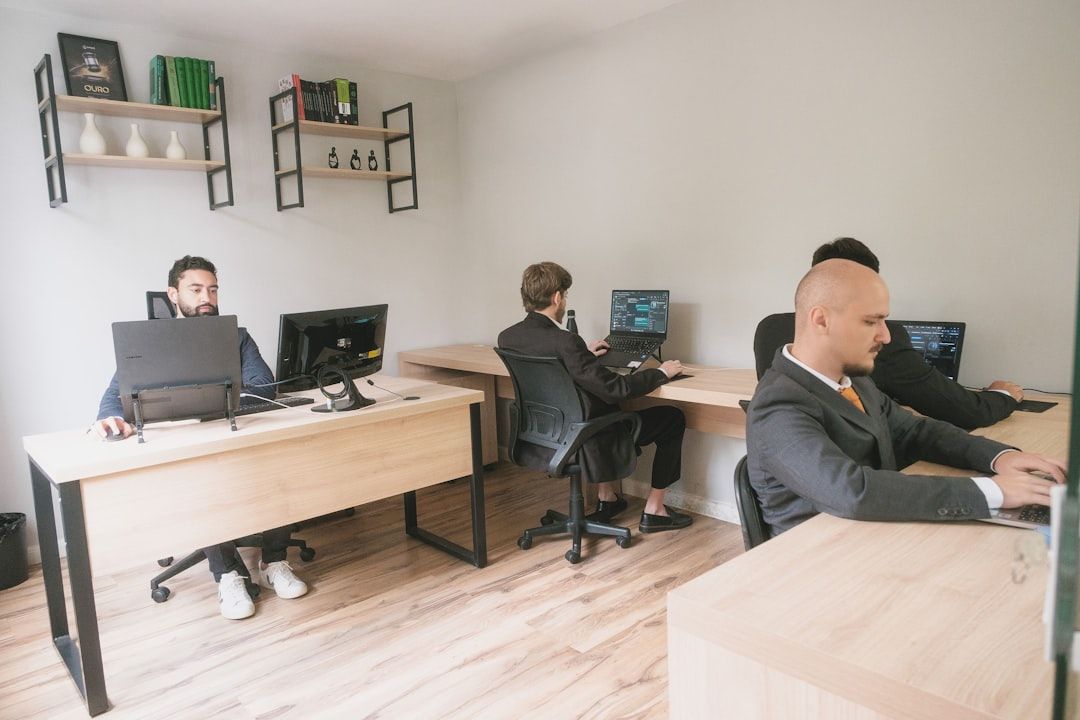 Men working on computers in a modern office.