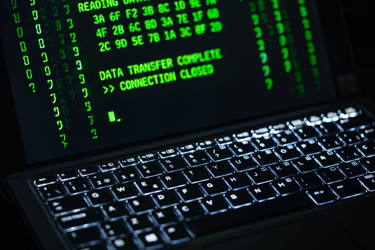 Close-up of a laptop screen displaying green code text. Perfect for cybersecurity themes.