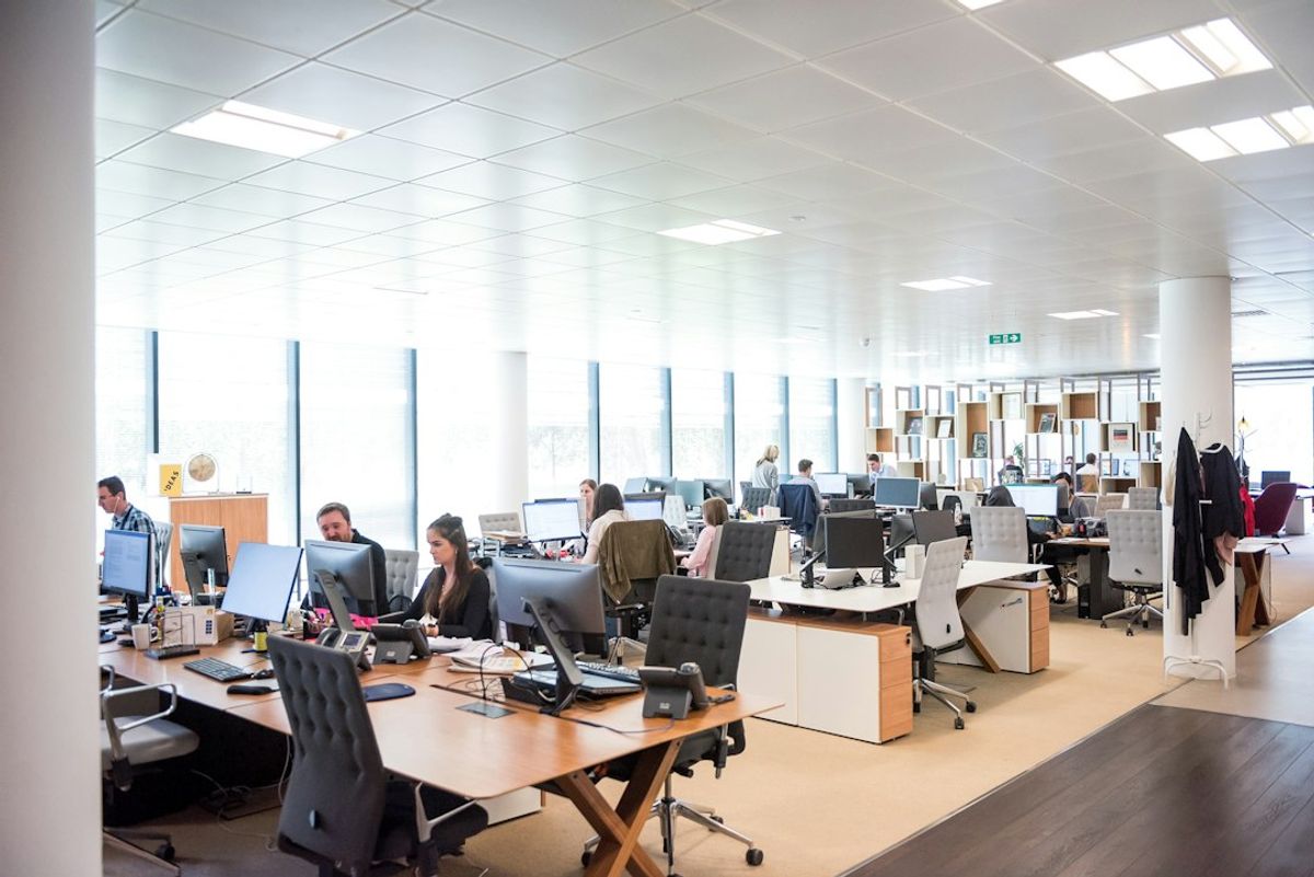 people working at desks in open office