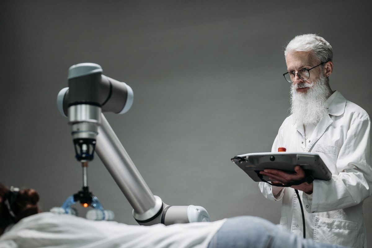 Senior scientist observing robot performing a task indoors.
