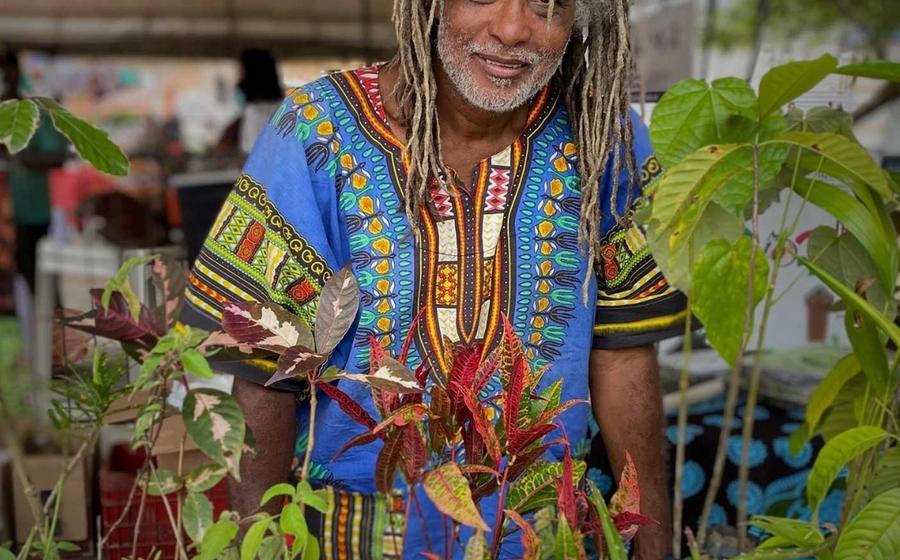 Mestre Cobra Mansa with plants in a market, Bahia, Brazil.