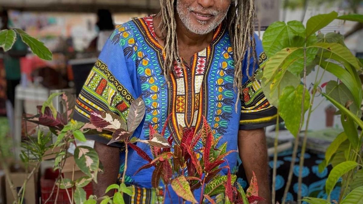 Mestre Cobra Mansa with plants in a market, Bahia, Brazil.