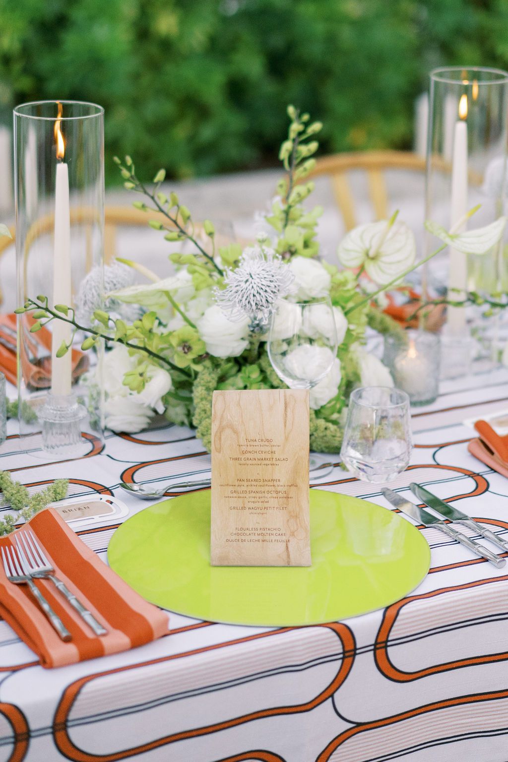 Chartreuse glass placemat charger set on a burnt orange Condesa art Deco style tablescape.