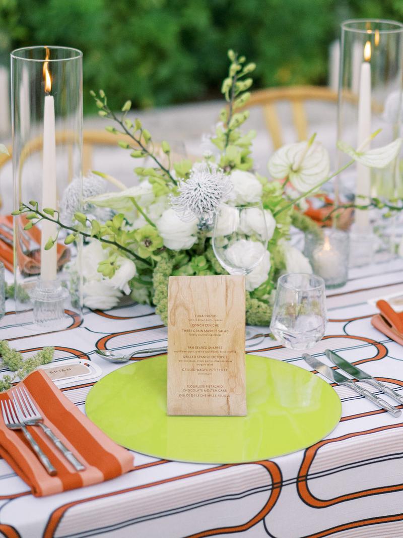 Chartreuse glass placemat charger set on a burnt orange Condesa art Deco style tablescape.