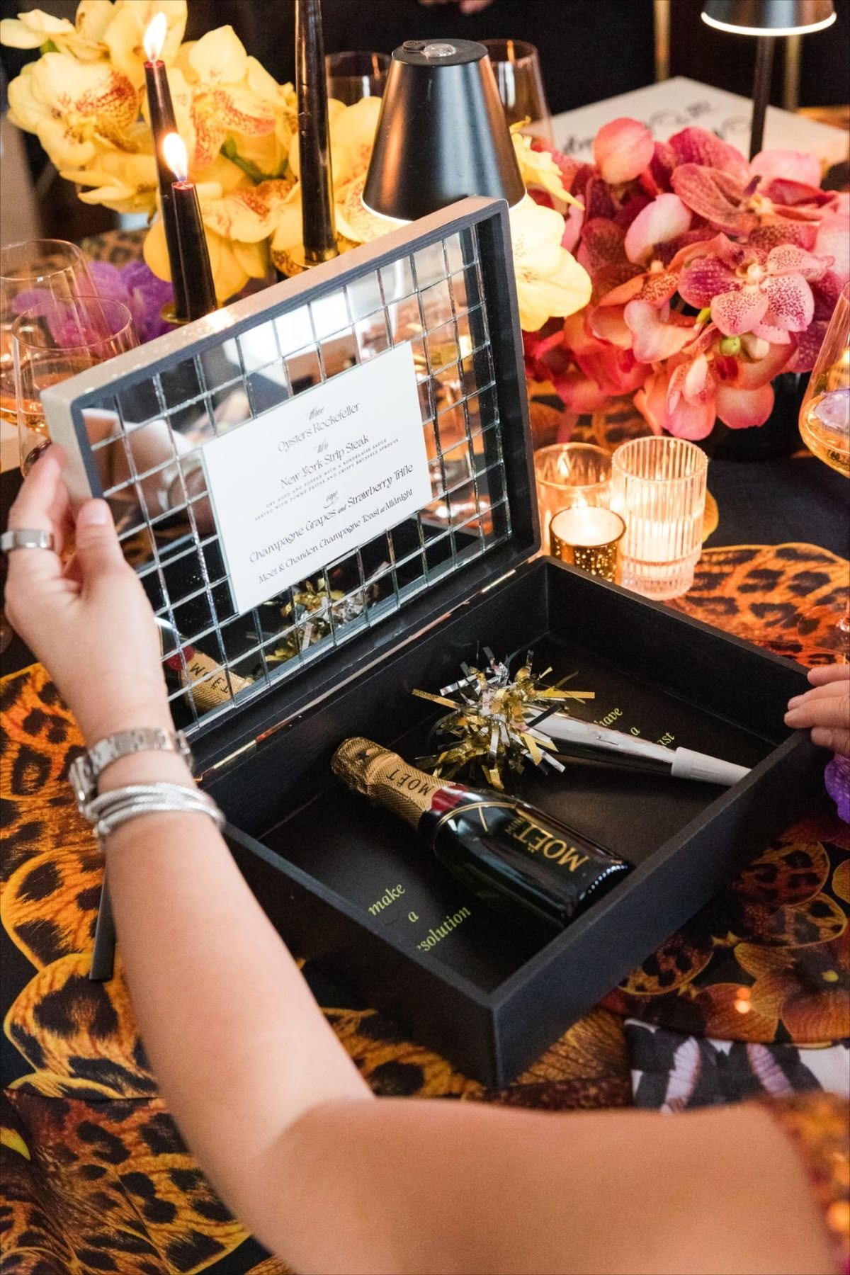 Black Orange Orchid Linen with a festive New Years box being opened on top.