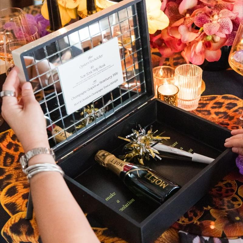 Black Orange Orchid Linen with a festive New Years box being opened on top.