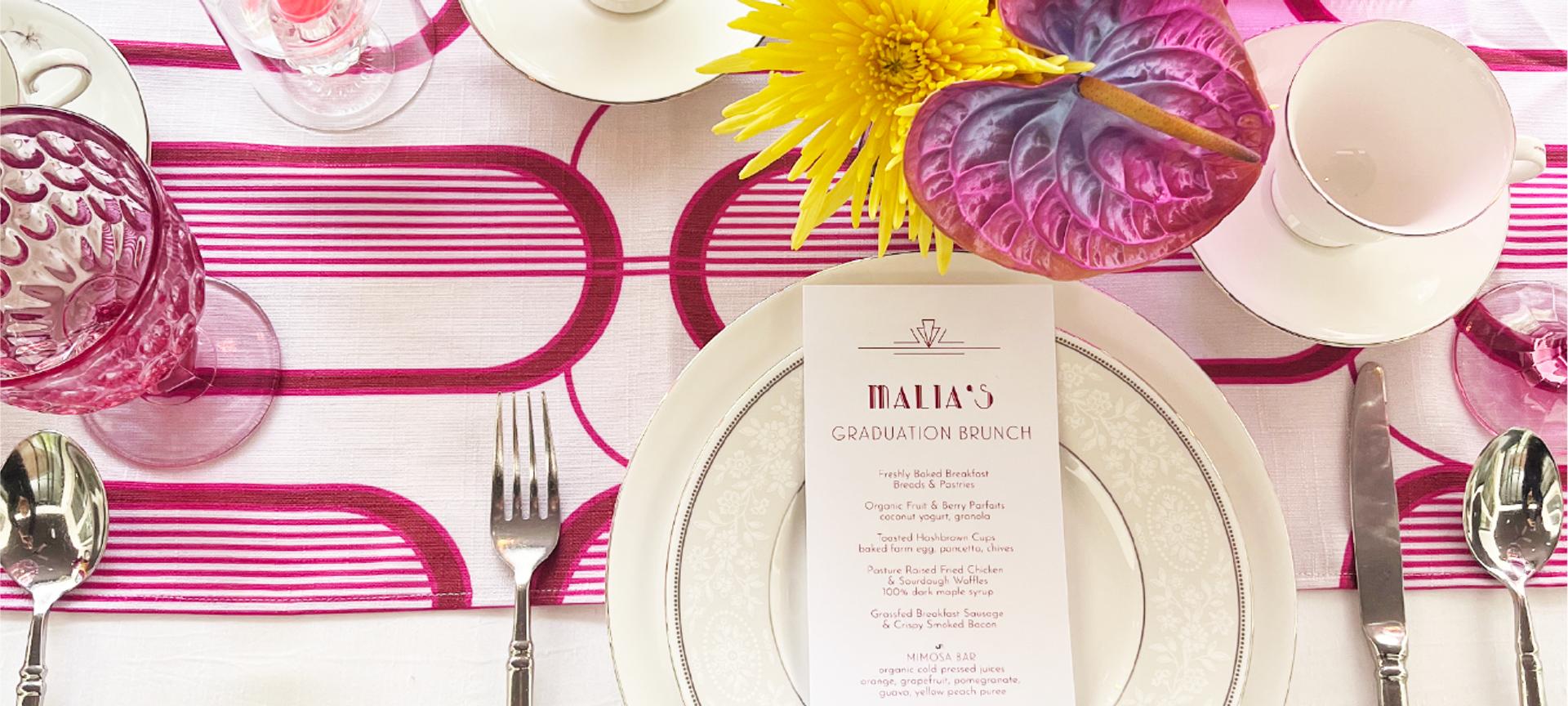 Pink tablescape with striped linens