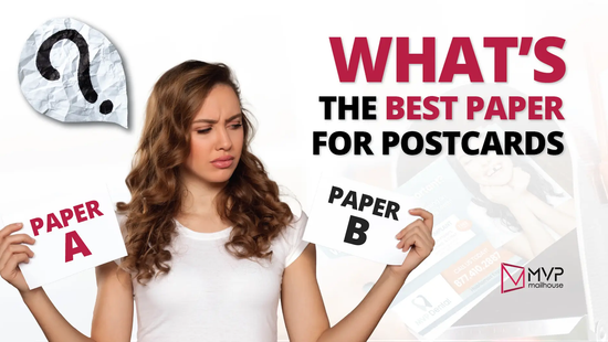 A young woman with long curly brown hair, wearing a white t-shirt, stands in the center of the image with a confused facial expression. She holds two white cards—one in each hand—labeled “PAPER A” in red and “PAPER B” in black, indicating indecision. A large, crumpled paper cutout of a question mark is visible to the left of her head. On the right, bold text reads, “WHAT’S THE BEST PAPER FOR POSTCARDS” with “WHAT’S” and “BEST PAPER” in red and “THE” and “FOR POSTCARDS” in black. In the background, there’s a faded image of a direct mail postcard partially inserted into a mailbox, showing a woman smiling on the card. The MVP Mailhouse logo appears in the bottom right corner in pink and black. The image conveys a theme of choice and uncertainty around selecting postcard paper.