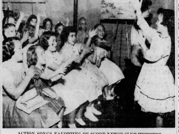 Newspaper article titled Good News Clubs Here Entertain 1000 Youths. An image shows a group of girls in frilly dresses sitting in a classroom and doing hand motions while another girl leads them.