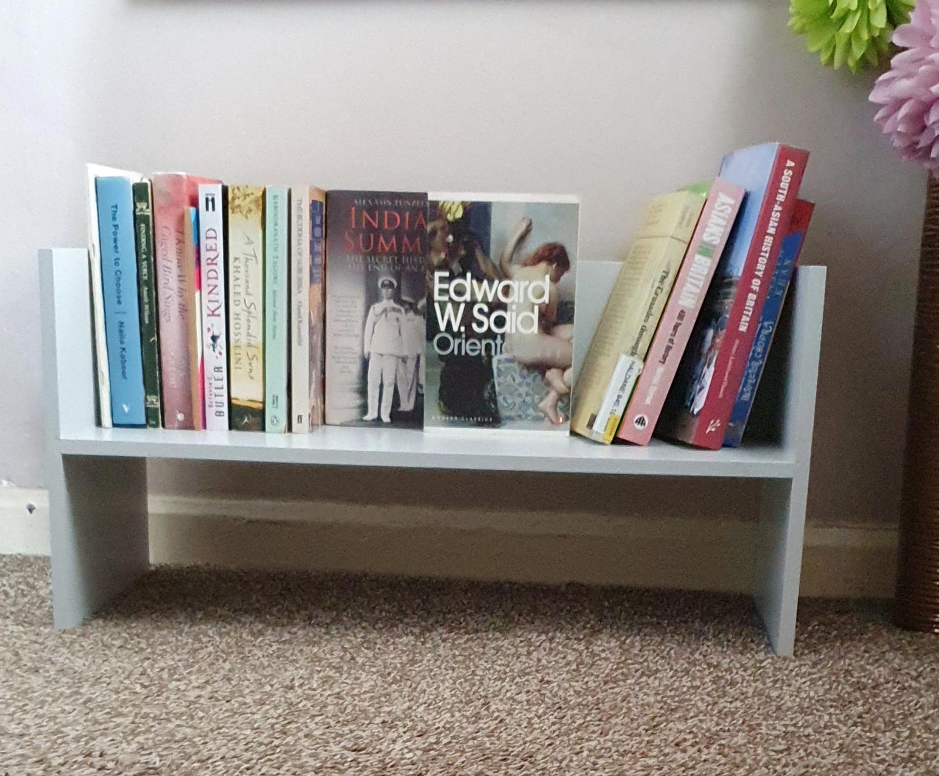 A free standing shelf of books