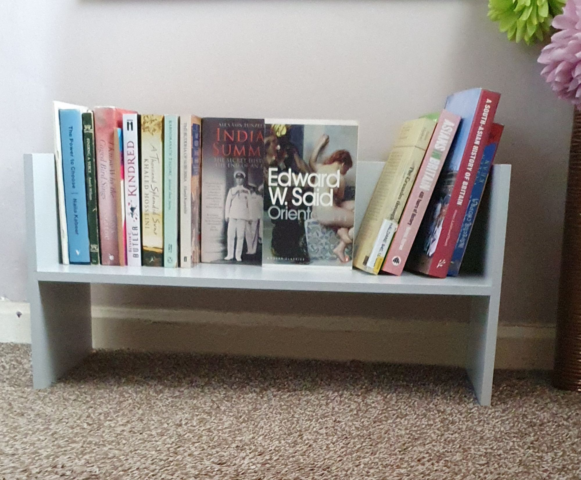 A free standing shelf of books
