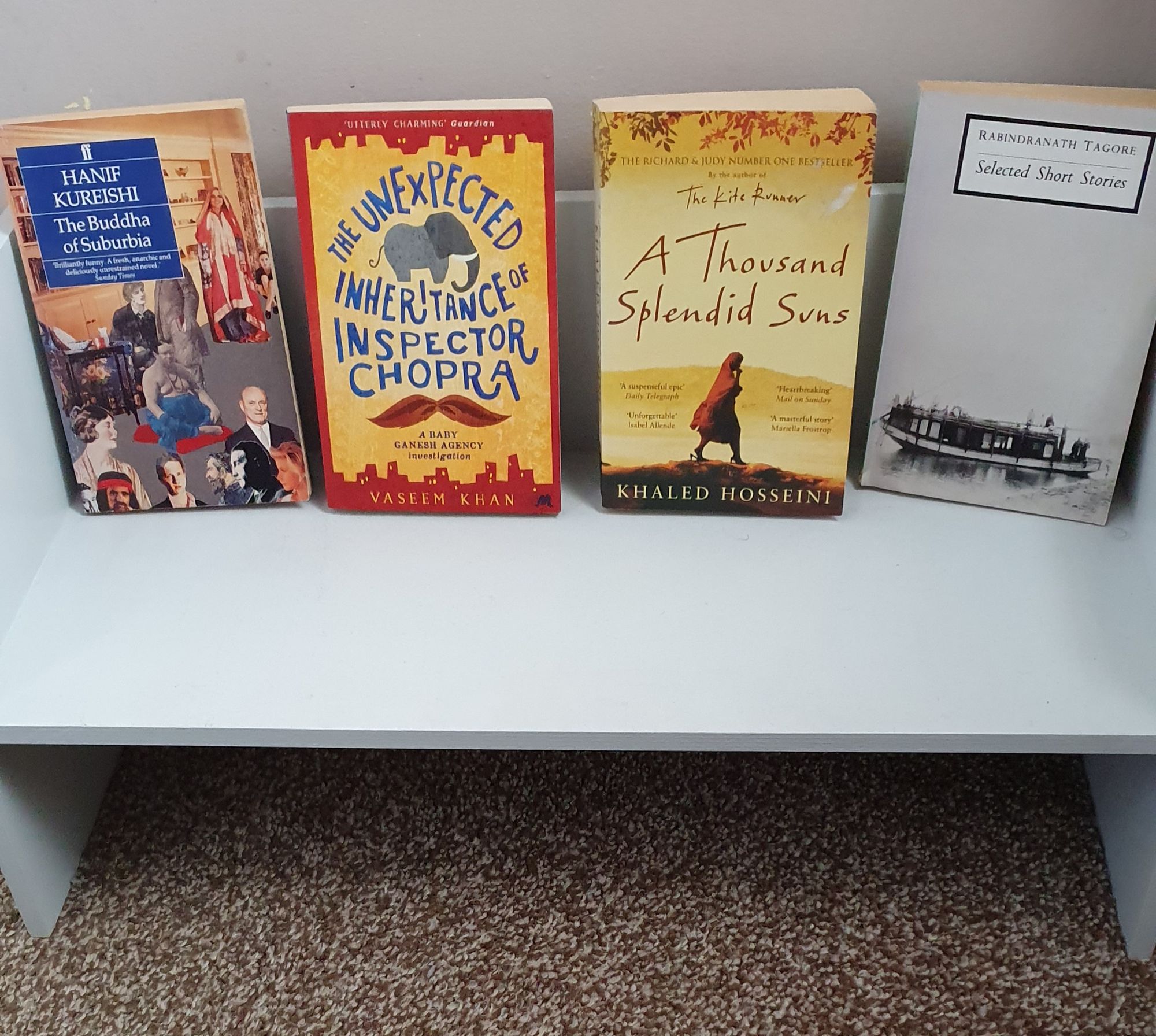 Selection of books by male authors on a free standing shelf