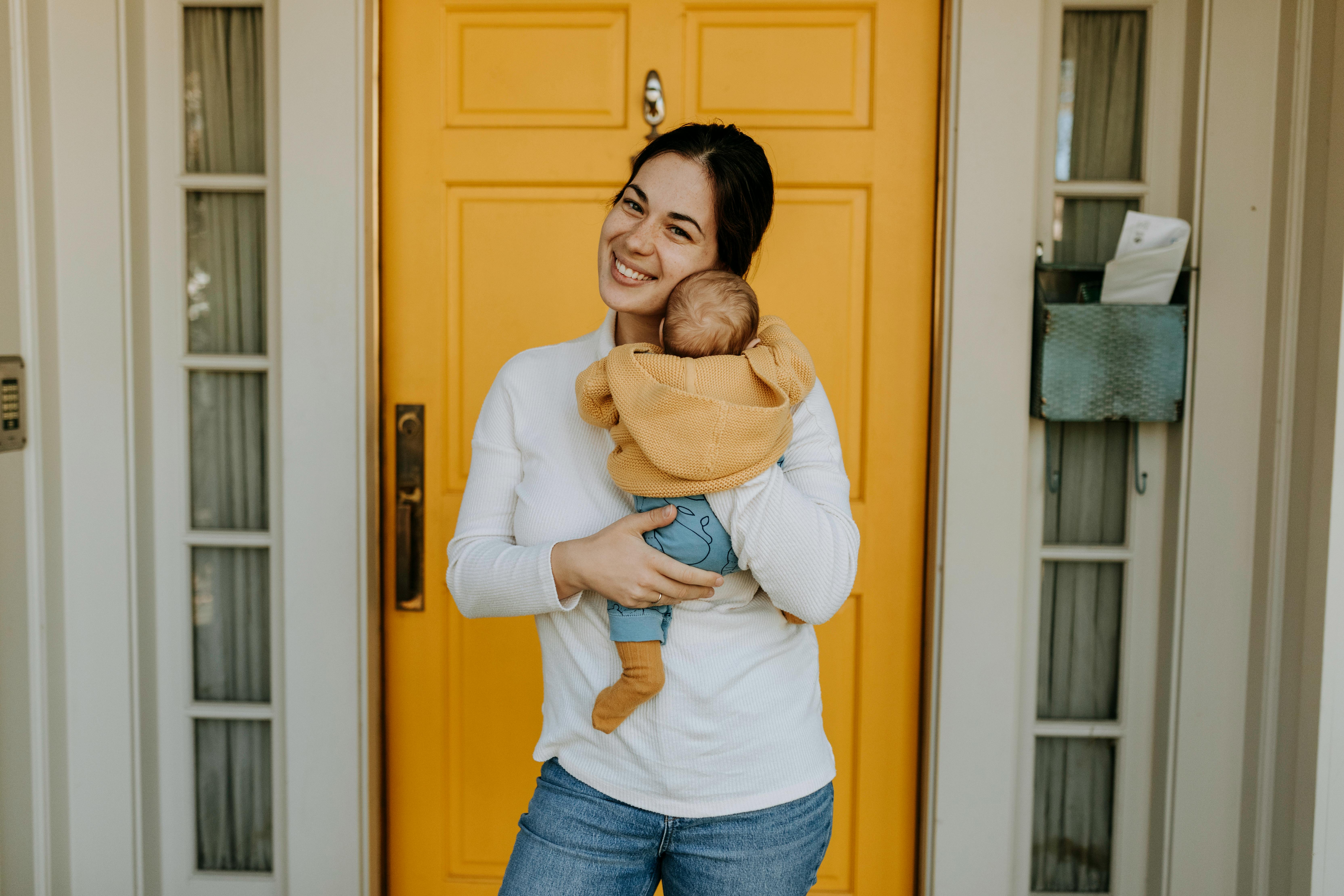 Sarah M. holding her new baby at home.