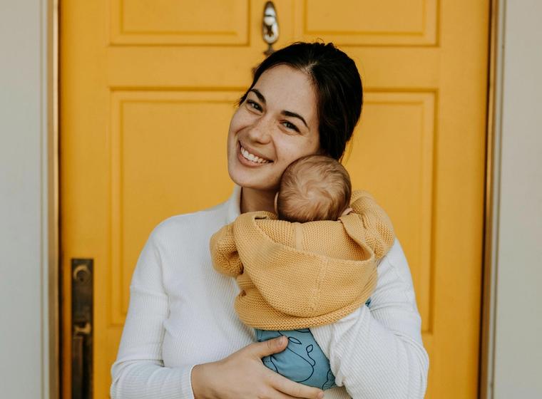 Sarah M. holding her new baby at home.
