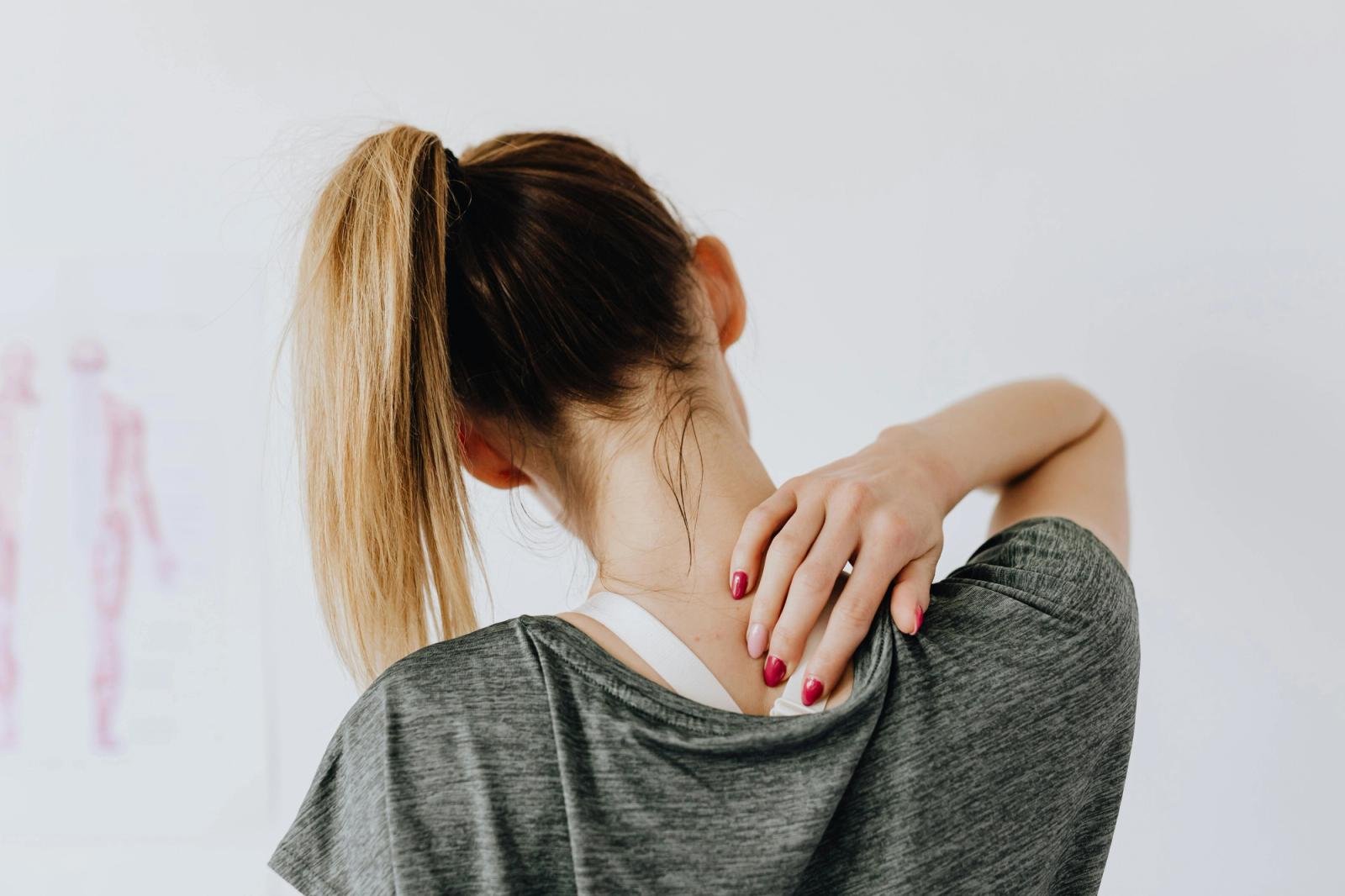 Physiotherapist performing hands-on manual therapy on a patient’s shoulder in a clinic