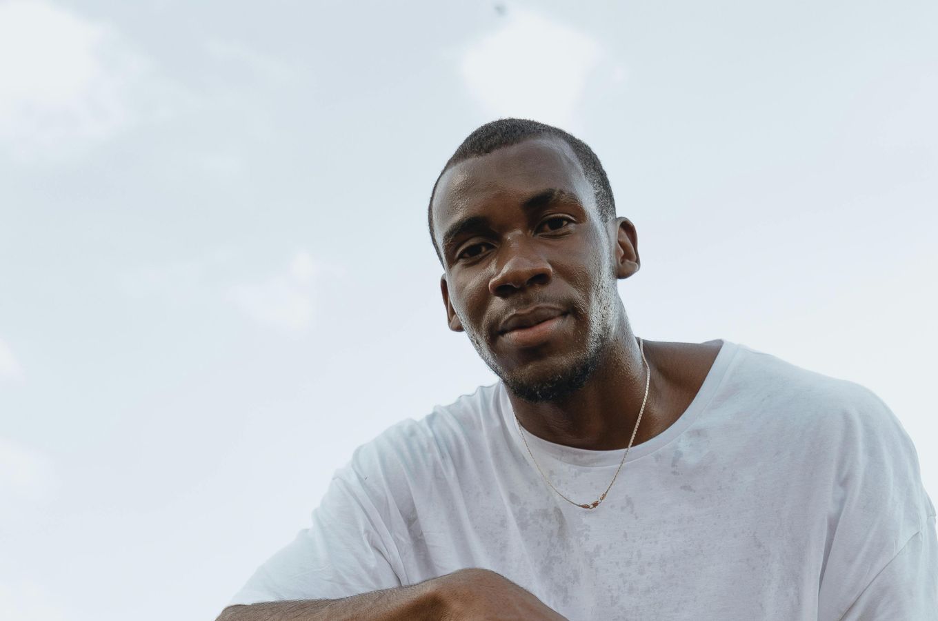 Marcus L. kneeling on a basketball court.