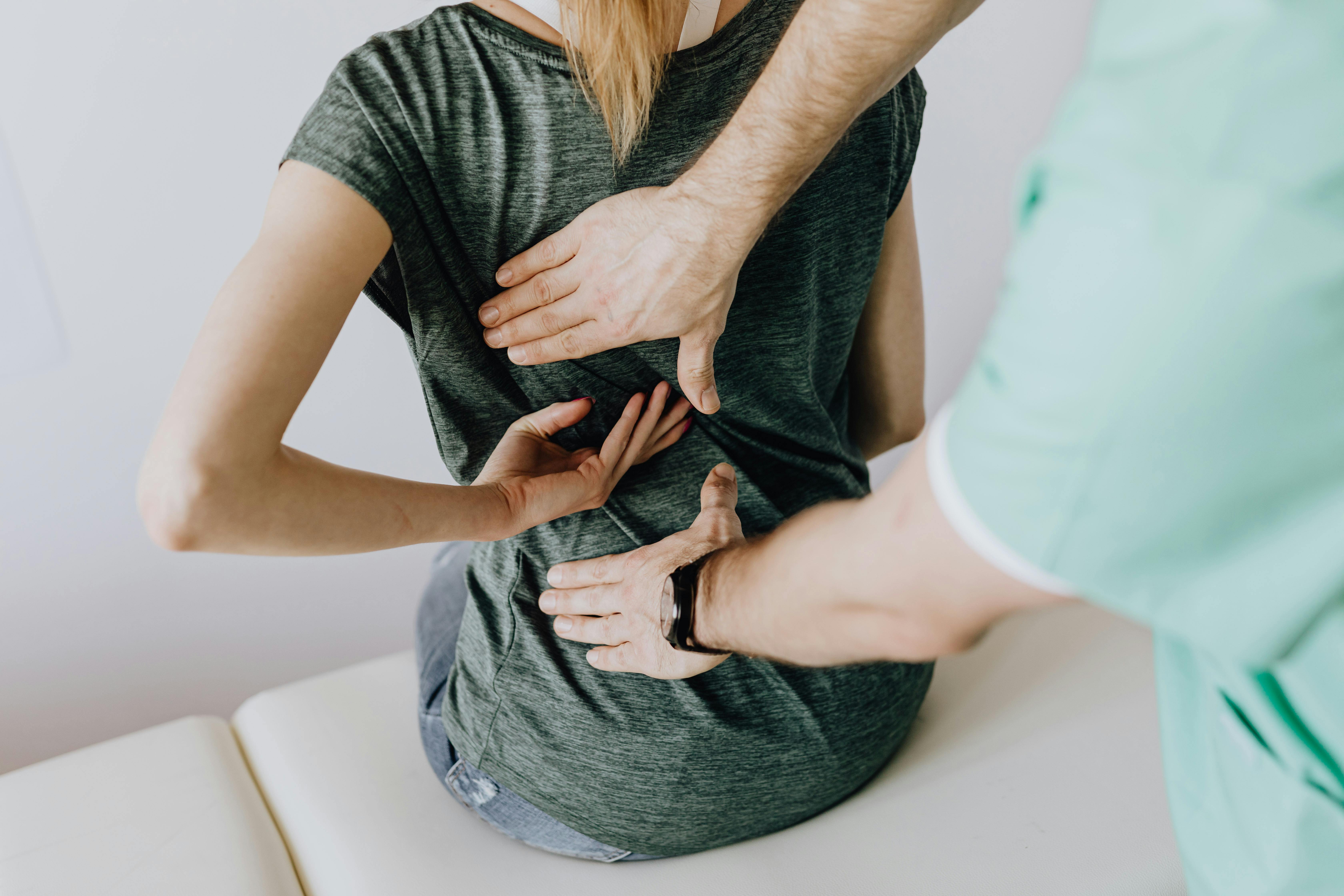 Acupuncture needles applied to patient's back during treatment session