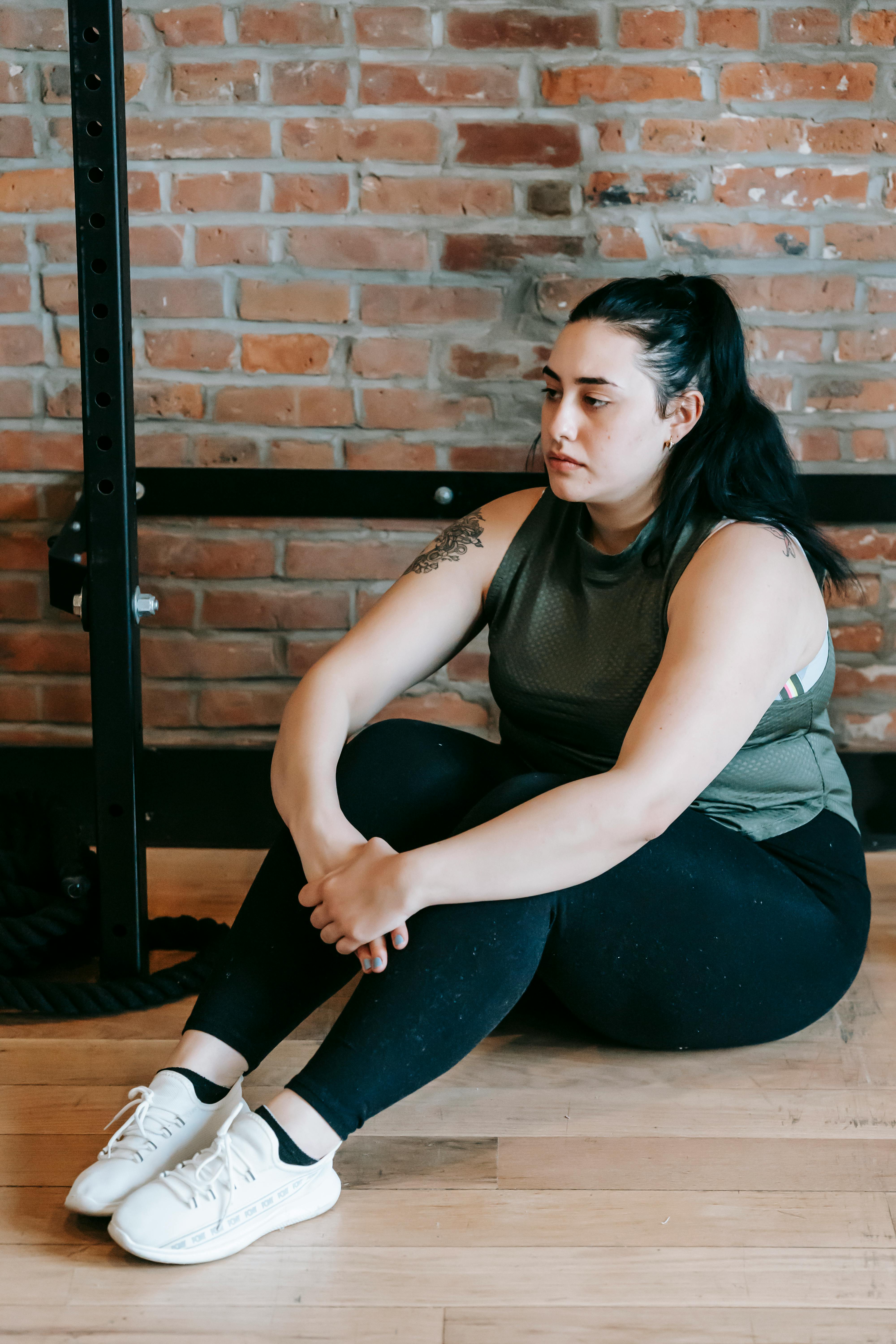 Athlete stretching leg after workout showing muscle soreness