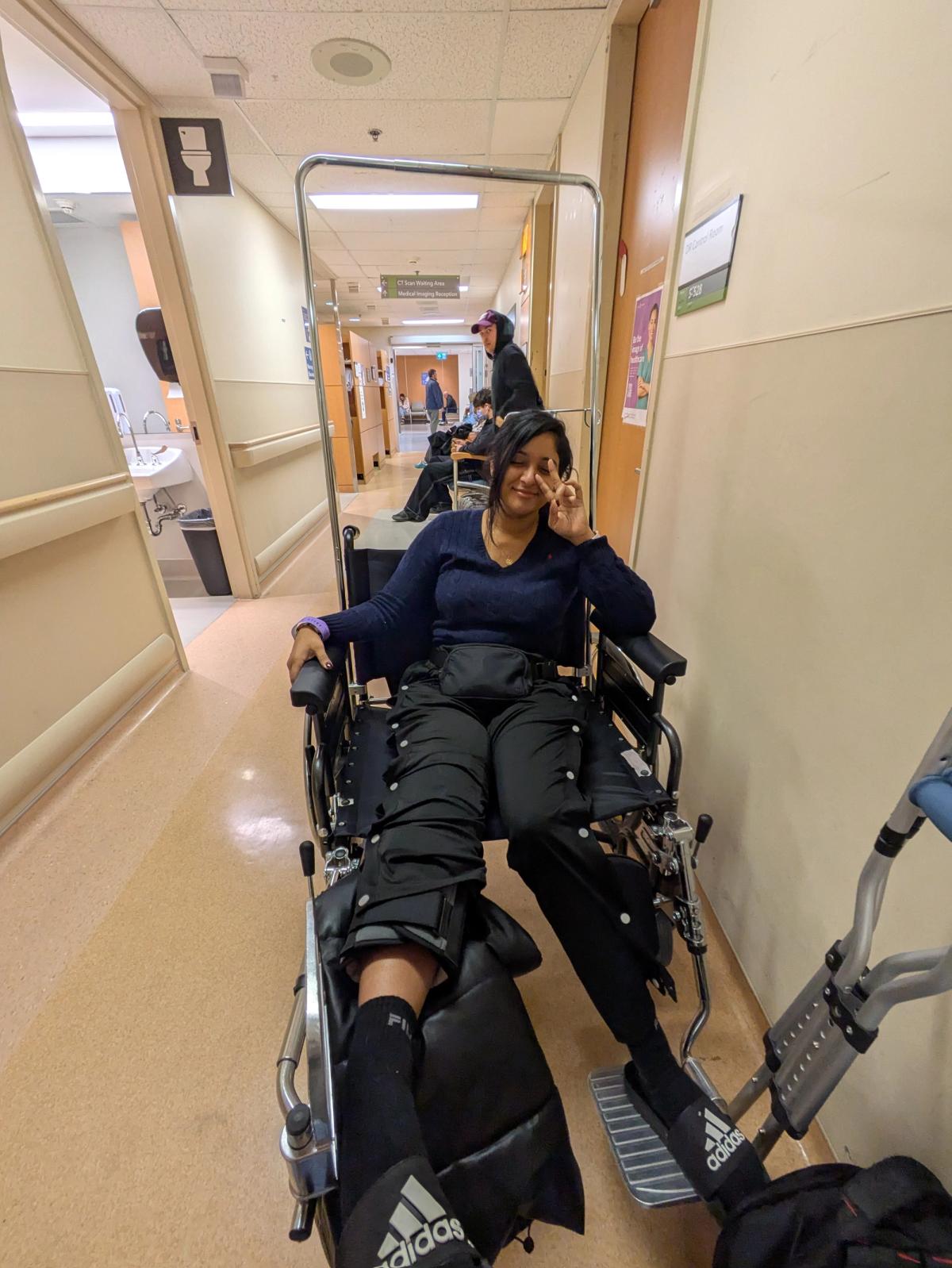 Marisa in a wheelchair post ACL reconstruction surgery.