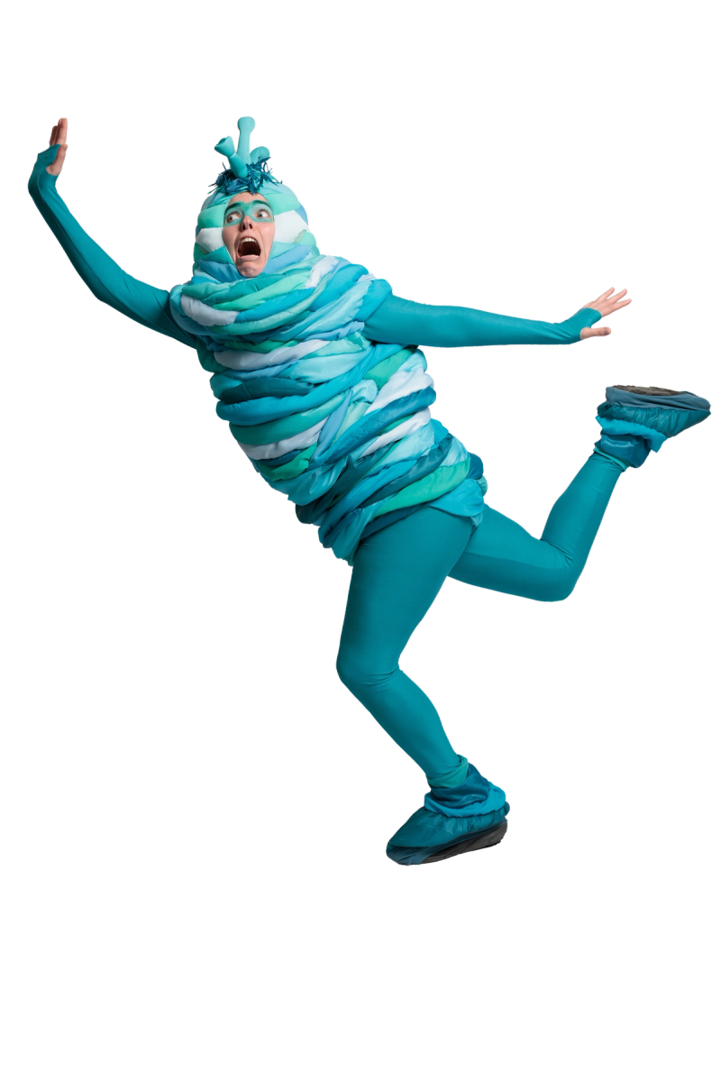 An alien character in a teal layered costume with antenna-like protrusions leaps mid-air with arms outstretched and mouth wide open in a dramatic, comedic expression of surprise or fright.