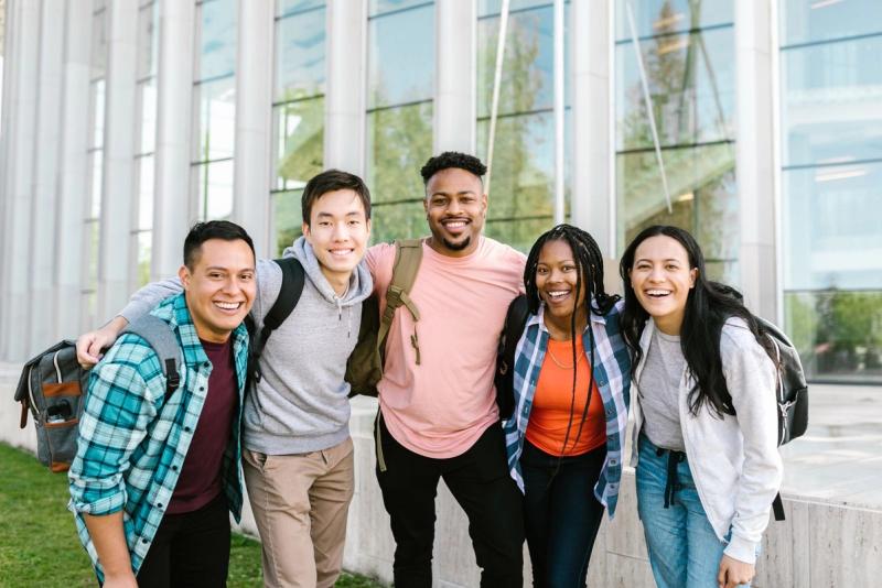 A group of students in front of a modern campus building