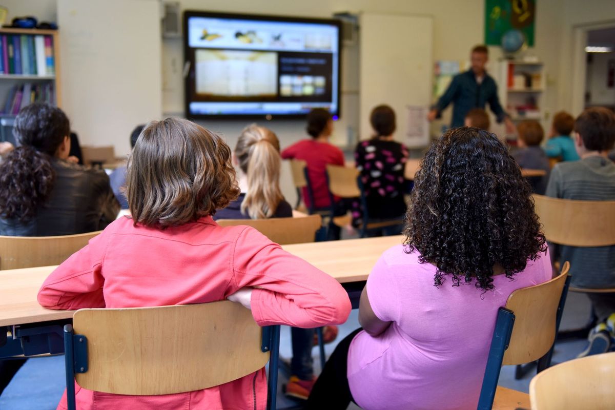 Modern classroom with a digital smartboard and students