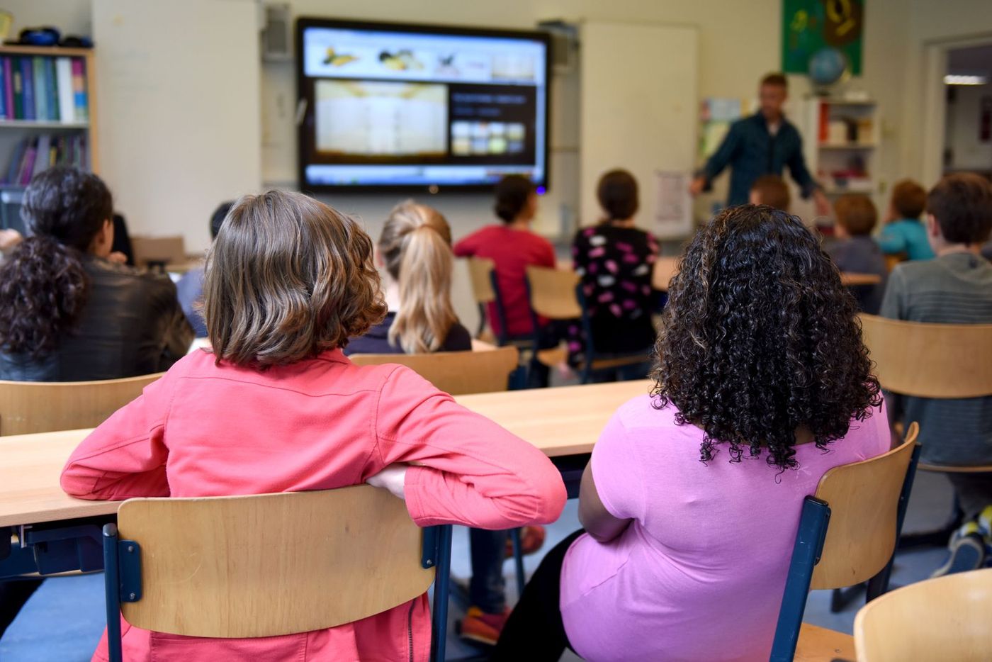 Modern classroom with a digital smartboard and students