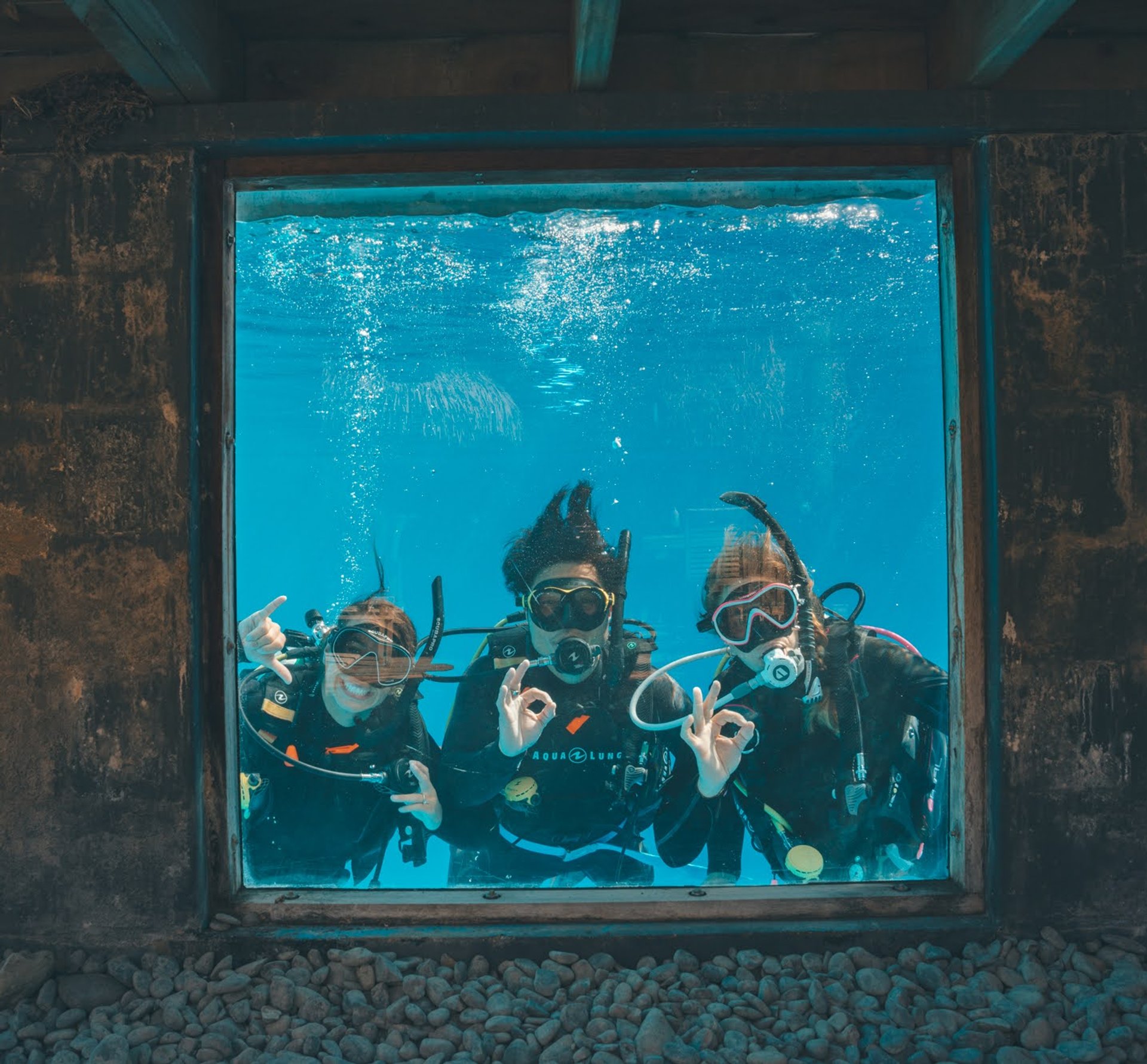 3 divers in a pool learning to dive at Dive Tutukaka in New Zealand 