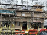 Front facade newly painted with scaffold