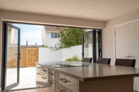 Interior shot of island in kitchen and double doors to garden