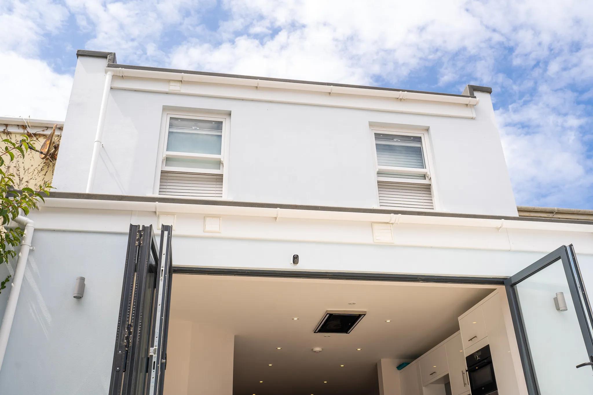 showing door design and upper floor windows