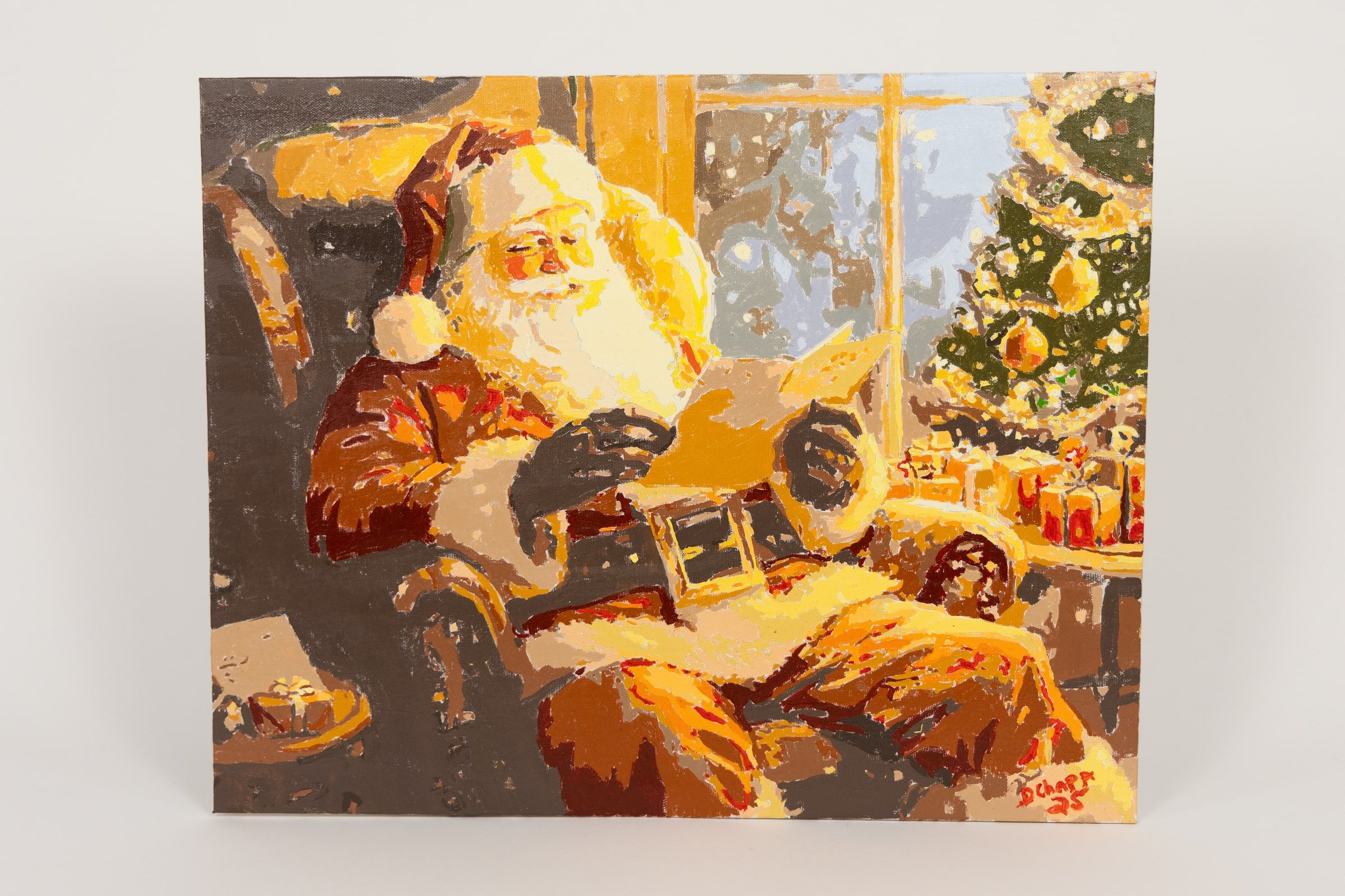 A painting of Santa Claus sitting back in an armchair beside a lit Christmas tree, his boots off, holding something in his lap.