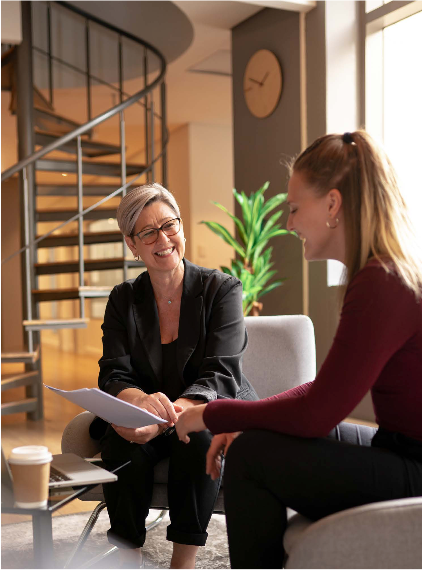 Two women reviewing paper