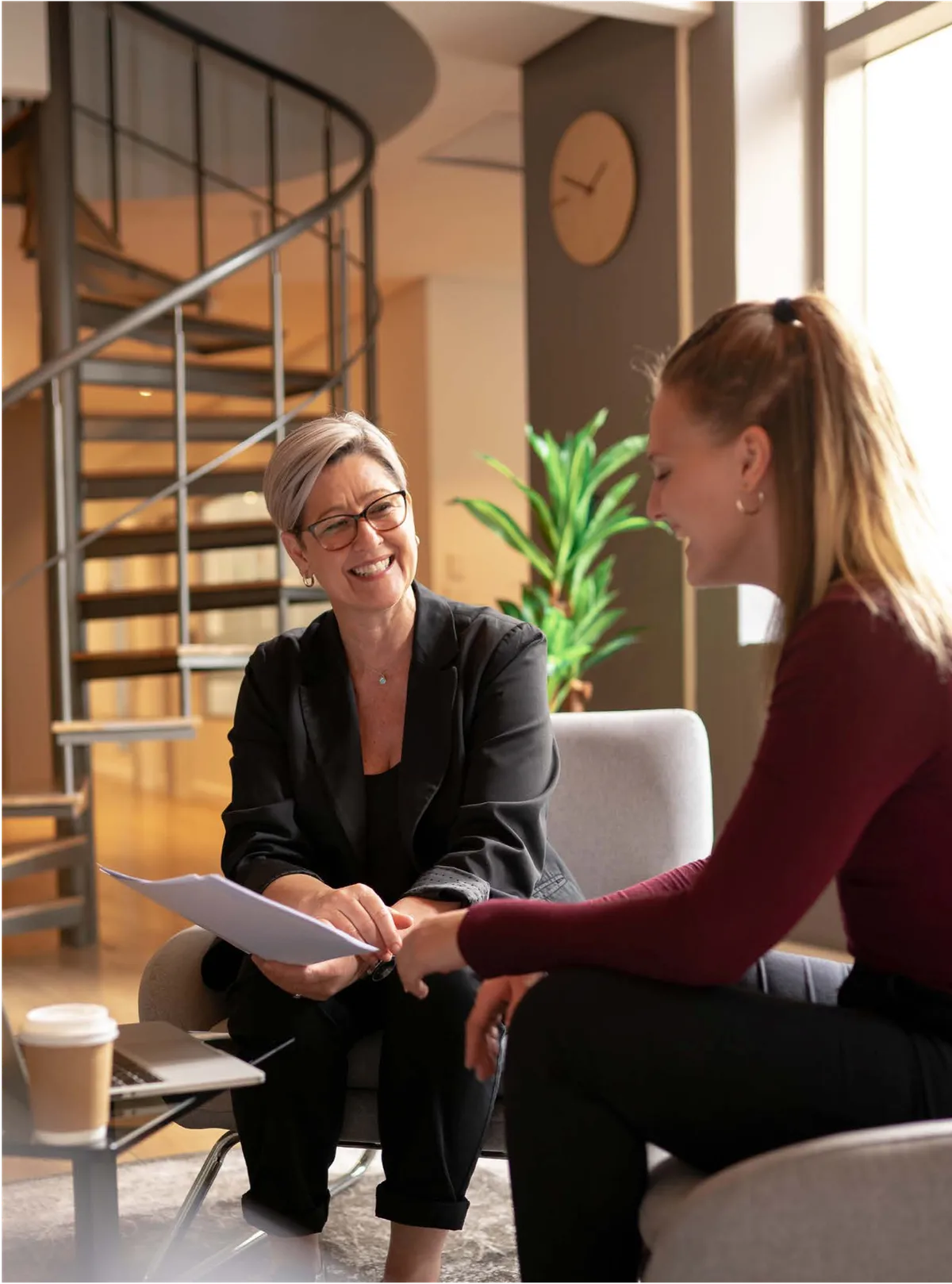 Two women reviewing paper