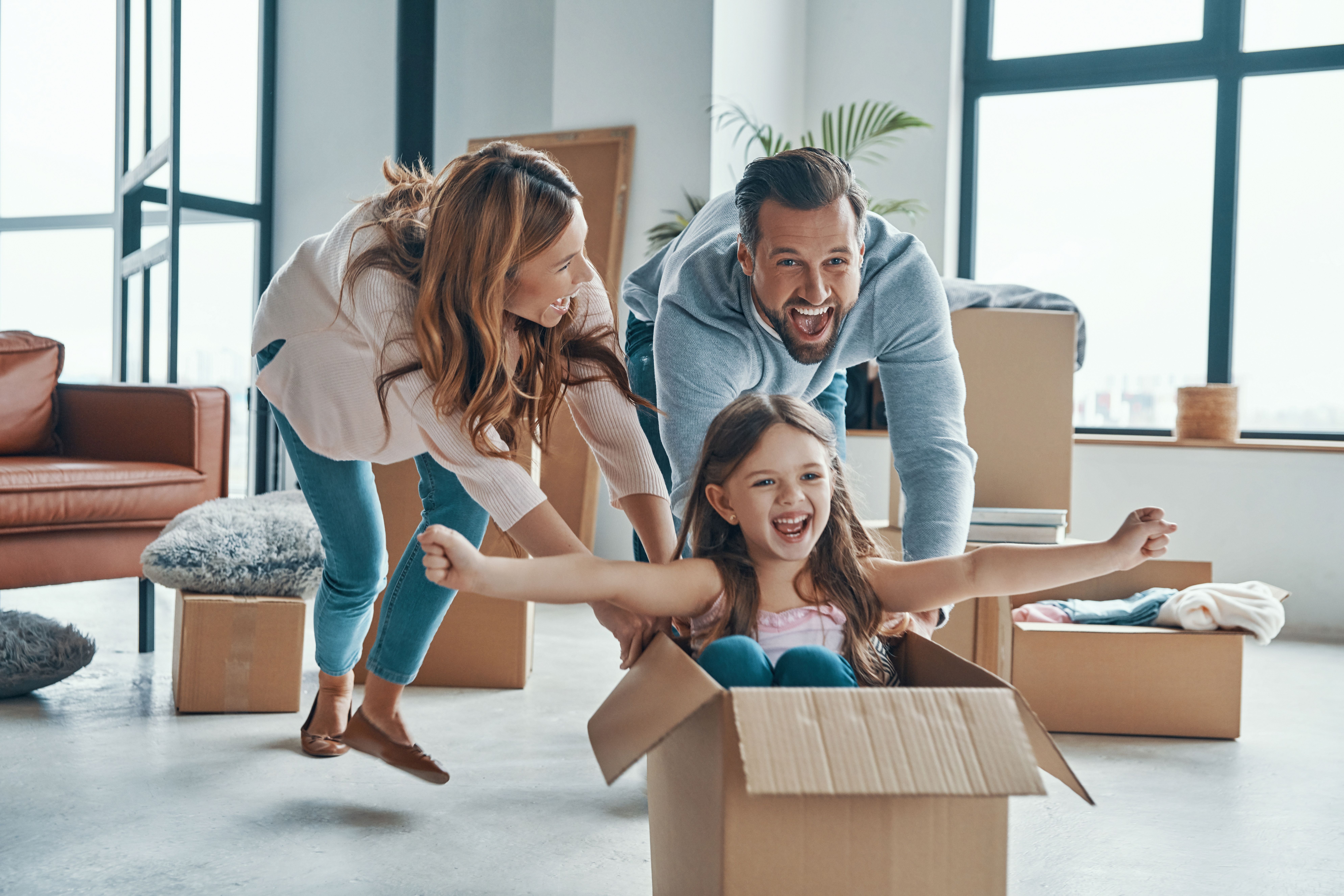 Couple holding moving boxes